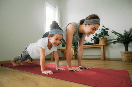 mom and daughter doing yoga at home
