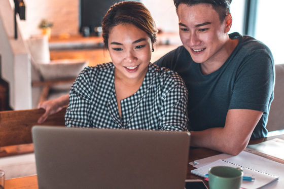 asian couple on computer