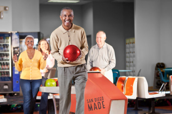 Mature friends bowling
