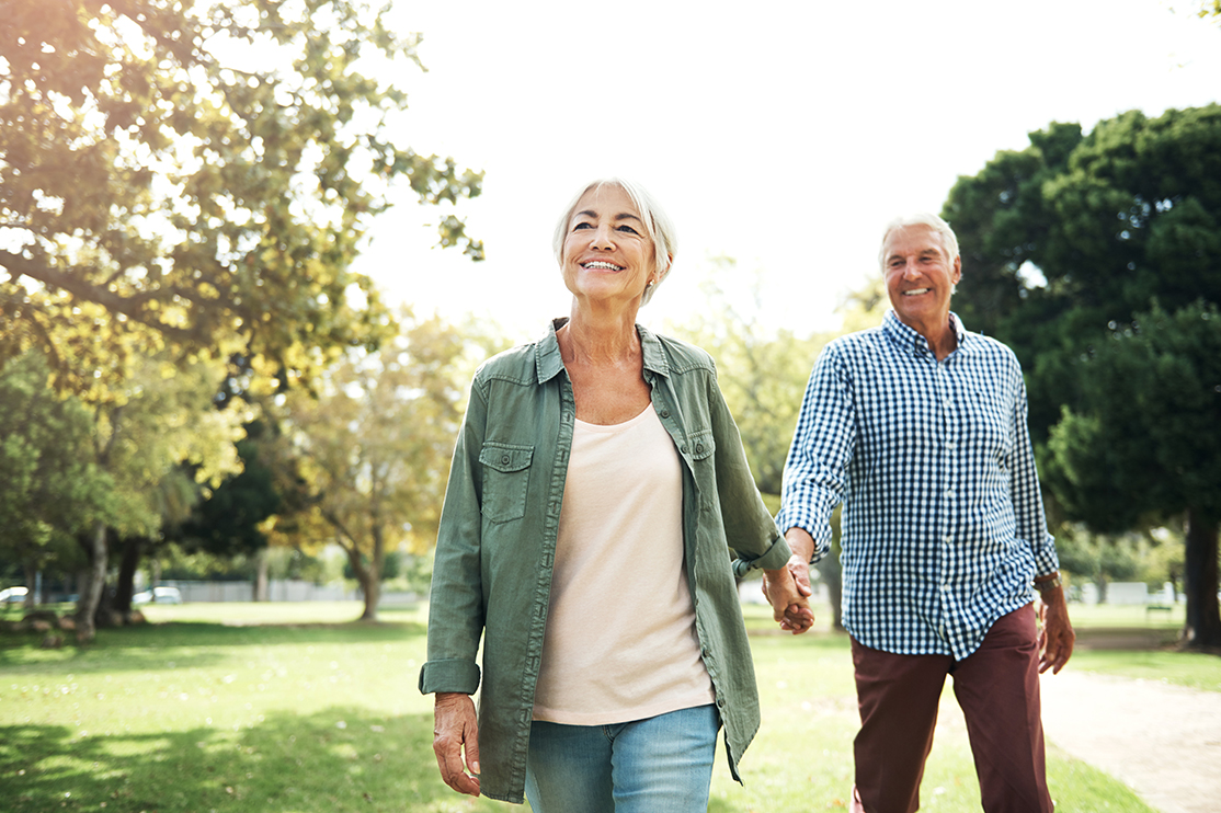 older couple walking in park