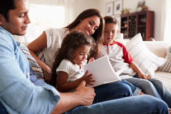 family sitting on sofa