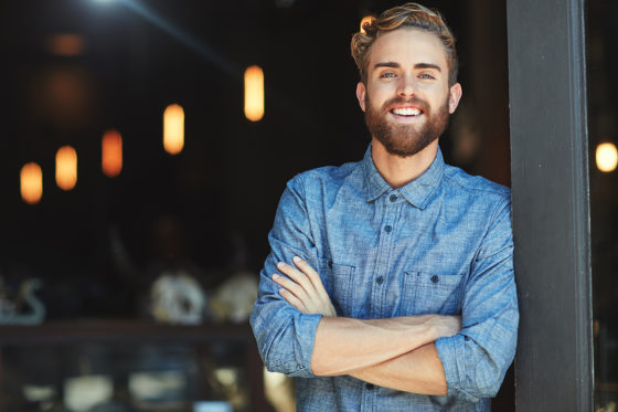 young man crossing arms