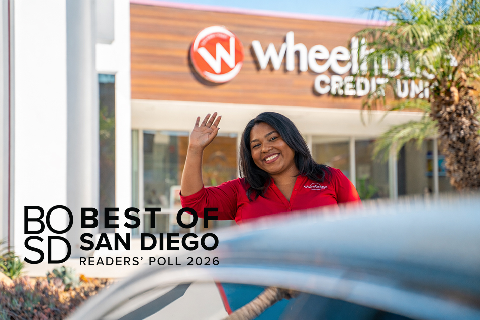 Wheelhouse employee standing outside of a branch, waving.