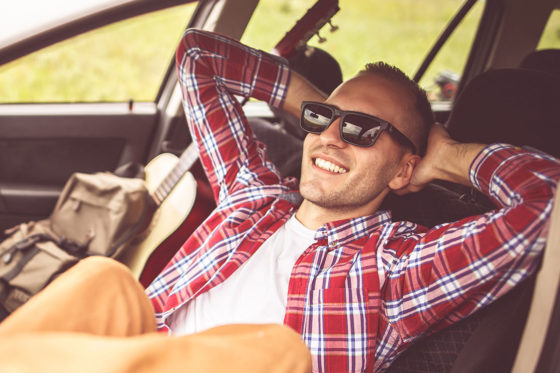 man relaxing behind the wheel