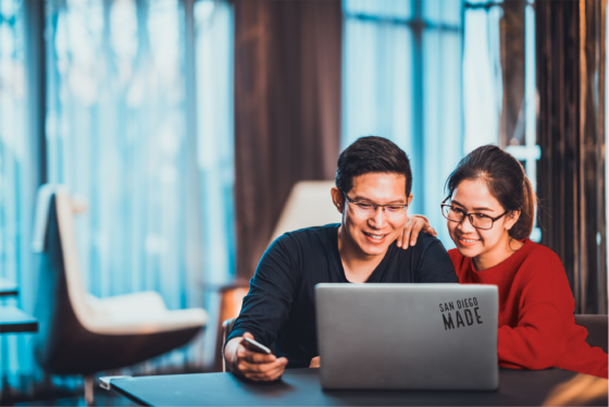 young asian couple working together on a laptop