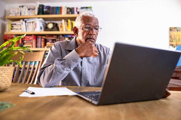 Older man using a laptop computer.