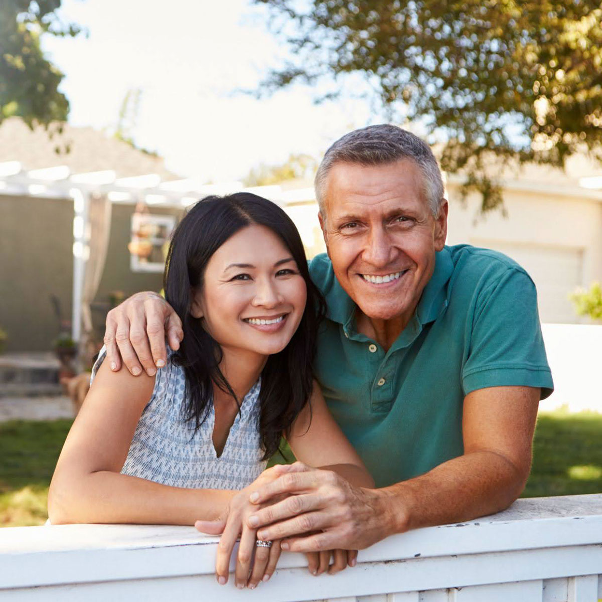 Photograph of a couple outside of a house.