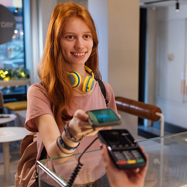 Young person using a smartphone to pay.