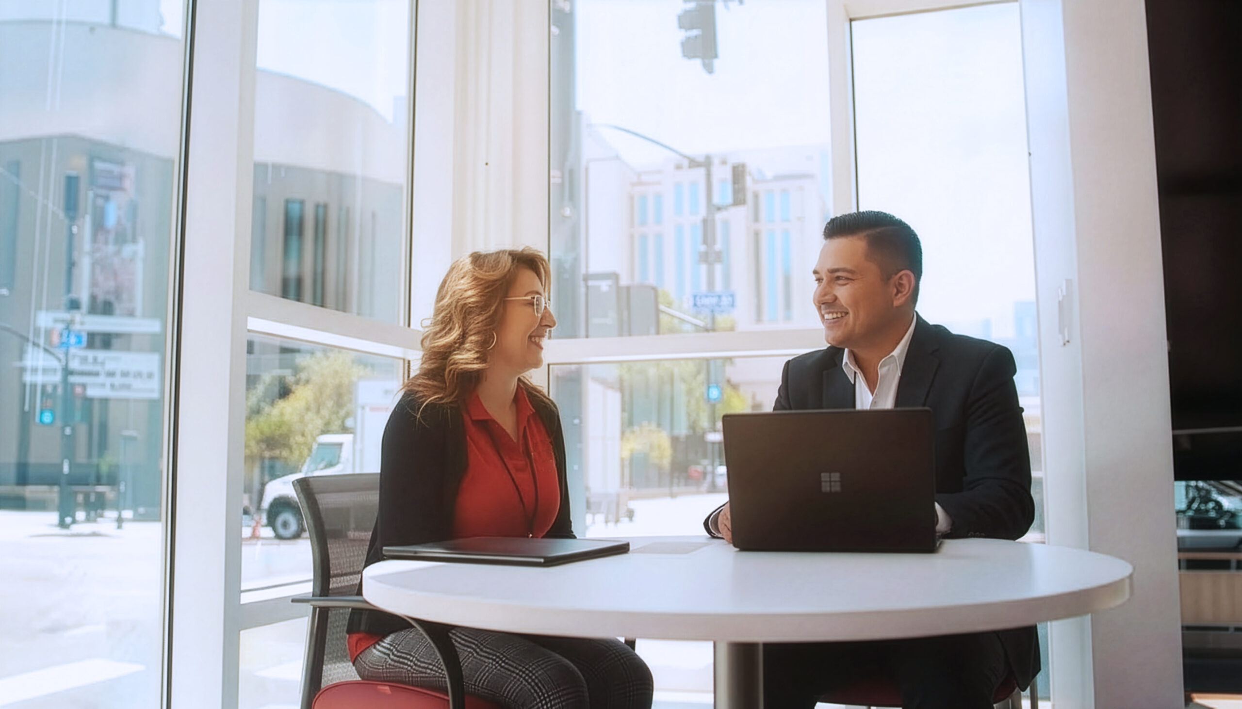 Two people inside of a credit union talking.