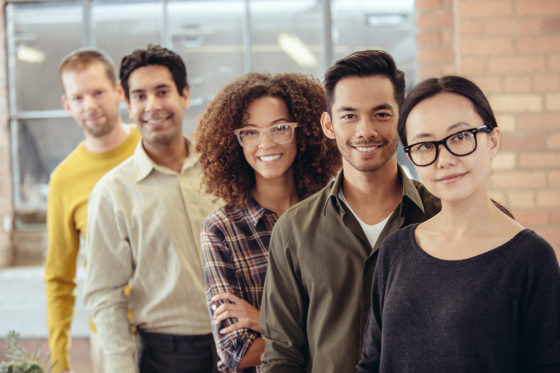 diverse group of smiling men and women standing together