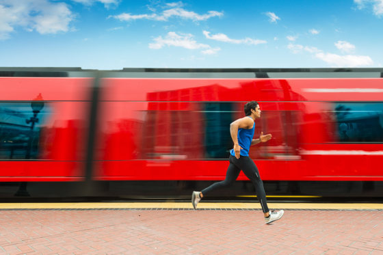 Man running aside a red train