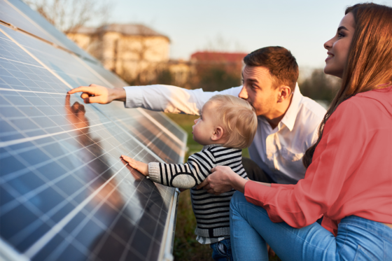 family looking at solar panels