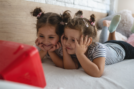 twin girls watching tv