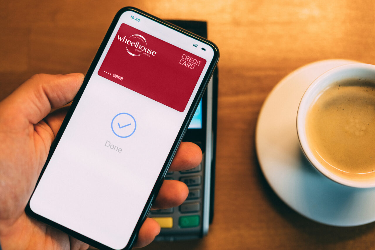 Man in cafe paying contactless with smart phone