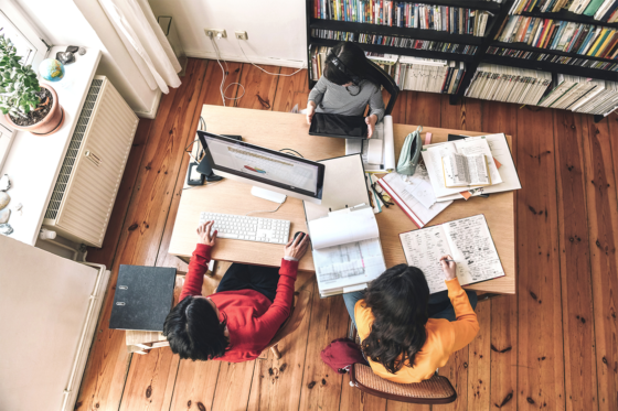 mother working from home with daughters e-learning