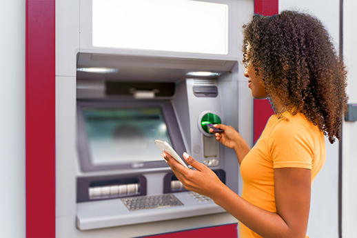 One black woman withdrawing money at an atm