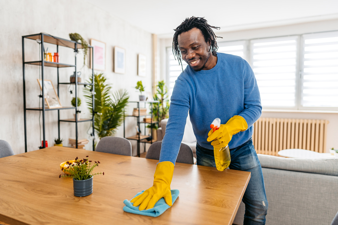 man cleaning table