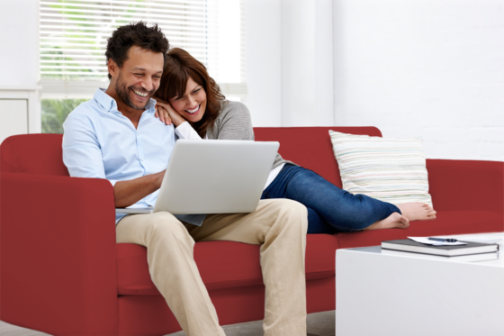couple on couch with laptop