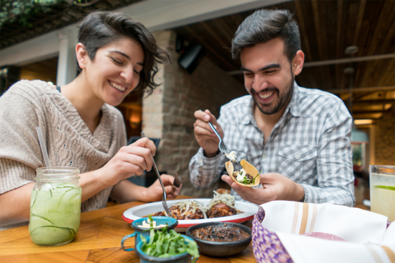 couple eating tacos outside