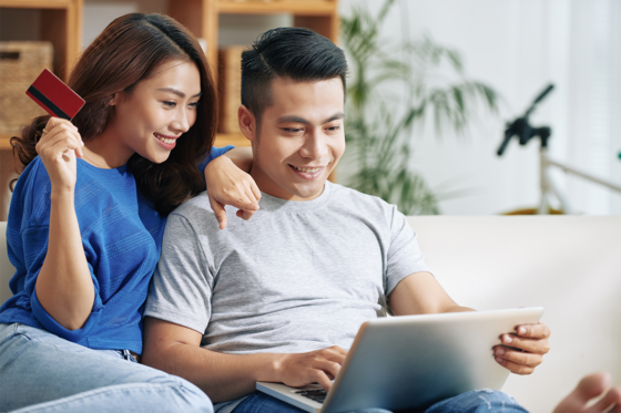 Happy couple making online purchase