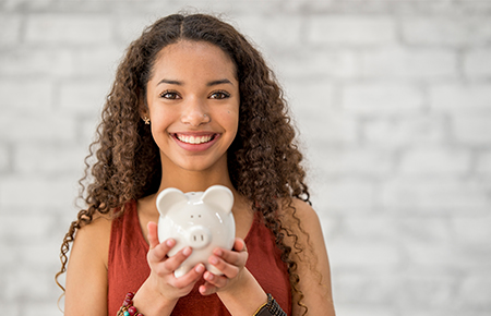 Woman holding a piggy bank