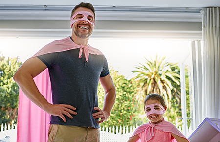 Dad and daughter dressed as superheroes